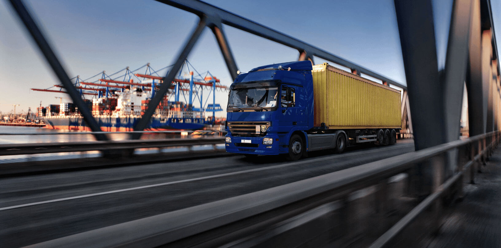 Symbolic image of a truck with container in front of the port's container terminal
