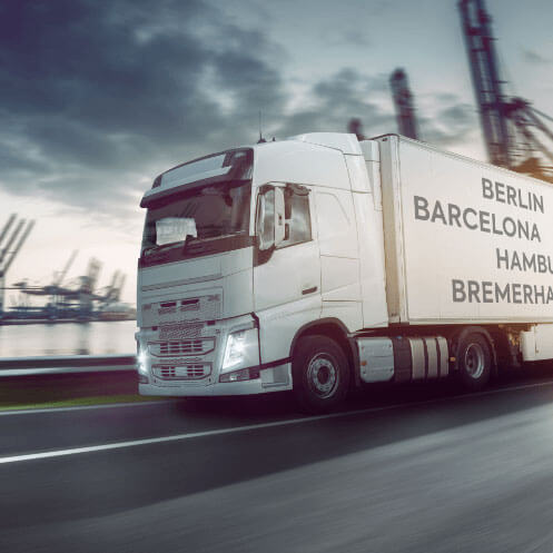 Symbolic image of a truck in front of a container terminal of the port